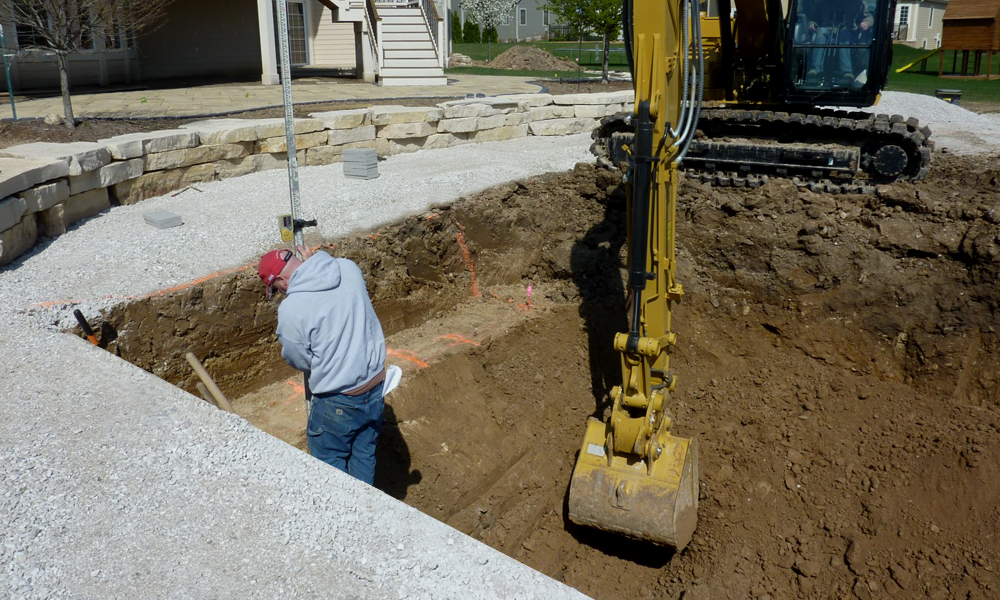 Digging the hole for fiberglass pool installation