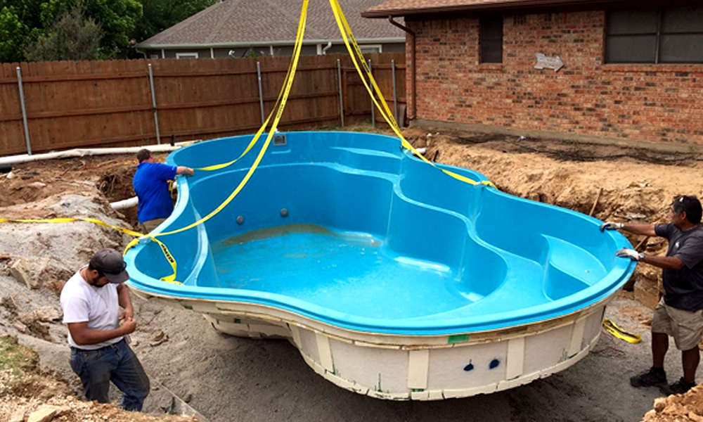 Pool installation - setting and leveling fiberglass pool shell in the hole